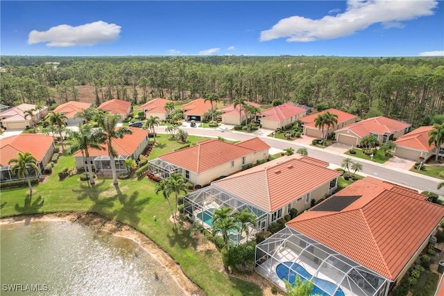 aerial view featuring a forest view and a residential view