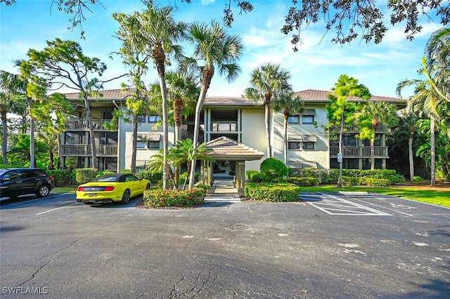 view of property featuring uncovered parking