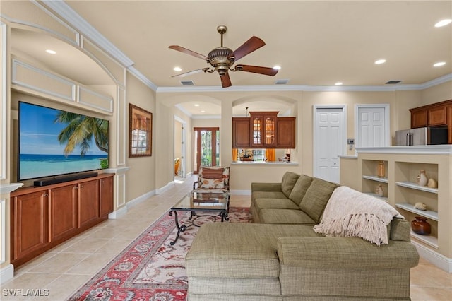 living room featuring light tile patterned floors, ornamental molding, and ceiling fan