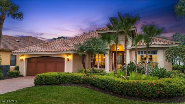 mediterranean / spanish-style home featuring a garage