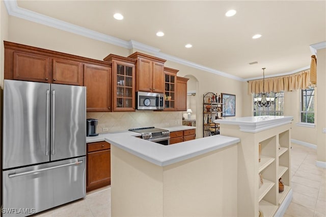 kitchen featuring light tile patterned floors, appliances with stainless steel finishes, backsplash, a chandelier, and crown molding