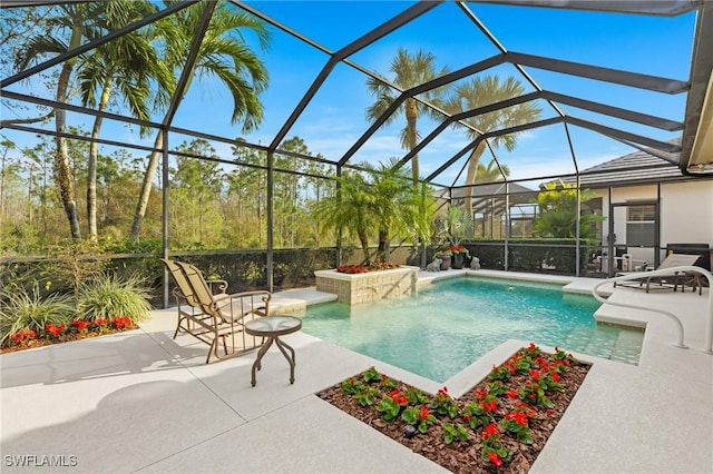 view of swimming pool with glass enclosure and a patio area