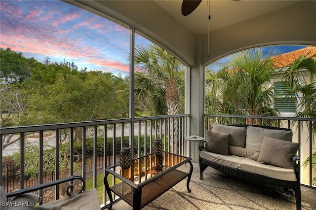 sunroom featuring ceiling fan and a wealth of natural light