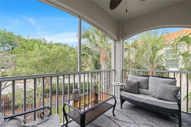 sunroom featuring ceiling fan