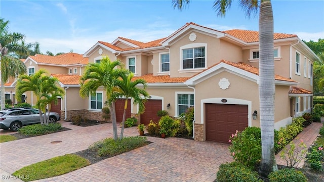 mediterranean / spanish-style home with a garage