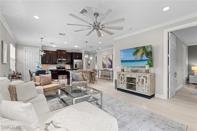 living room featuring ceiling fan with notable chandelier, crown molding, and light hardwood / wood-style flooring