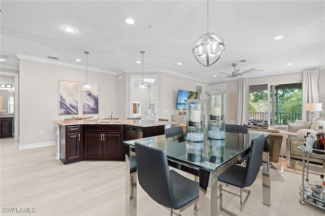 dining area with ceiling fan with notable chandelier, sink, light hardwood / wood-style flooring, and ornamental molding