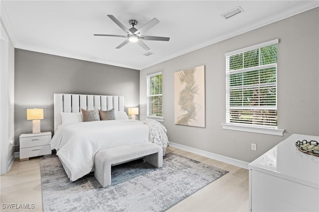 bedroom with ceiling fan and crown molding