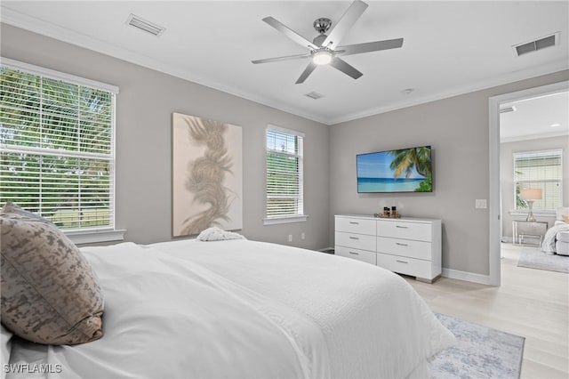 bedroom featuring ceiling fan, crown molding, and light wood-type flooring