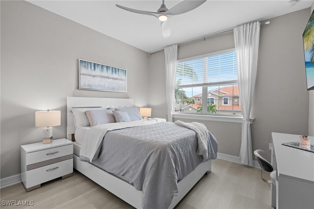 bedroom with ceiling fan and light hardwood / wood-style floors