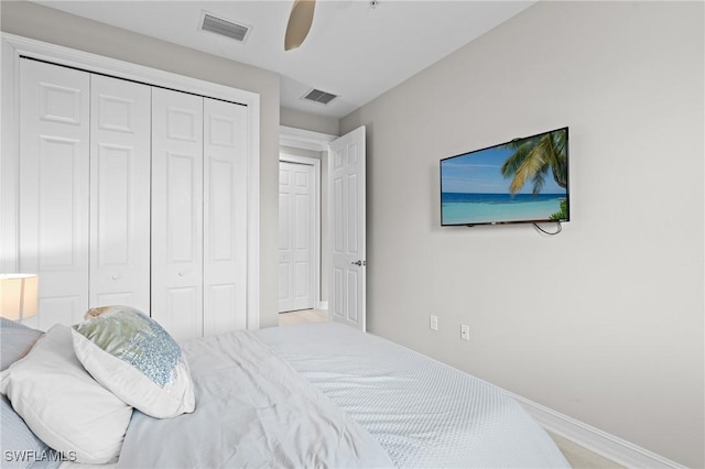 bedroom with ceiling fan and a closet