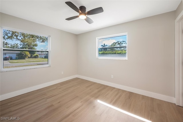 empty room with ceiling fan and light wood-type flooring