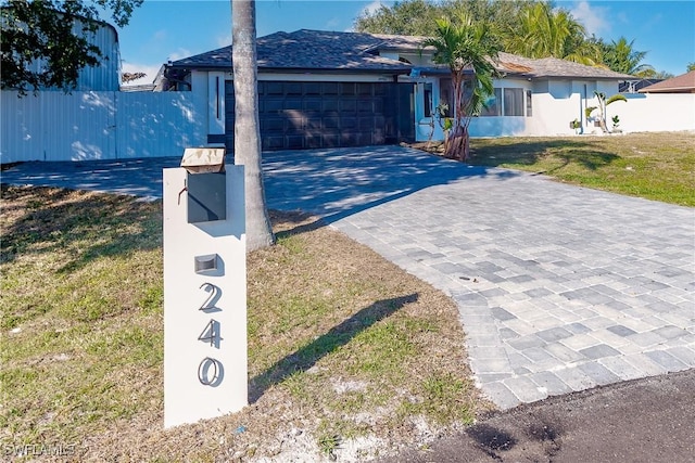 view of front of house featuring a front lawn and a garage