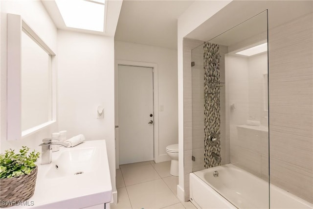 full bathroom featuring shower / bathtub combination with curtain, tile patterned flooring, toilet, a skylight, and vanity