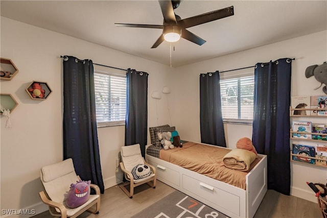 bedroom with wood-type flooring and ceiling fan