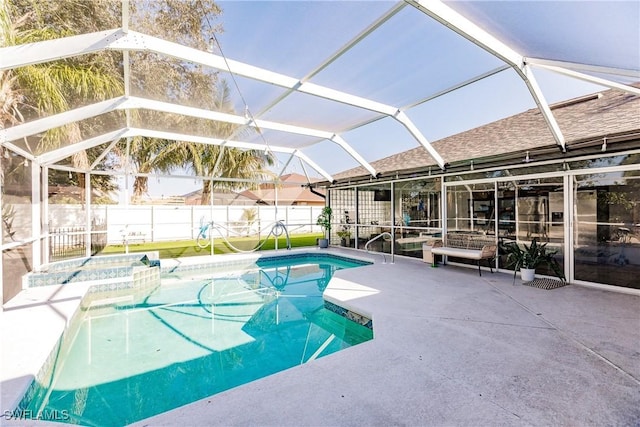 view of swimming pool with a lanai, a patio area, and an in ground hot tub