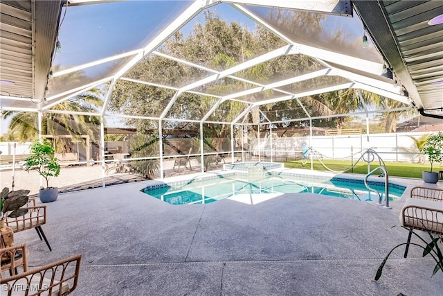 view of swimming pool featuring a lanai, a patio area, and an in ground hot tub