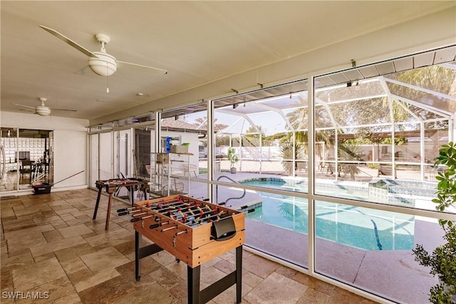 interior space with ceiling fan