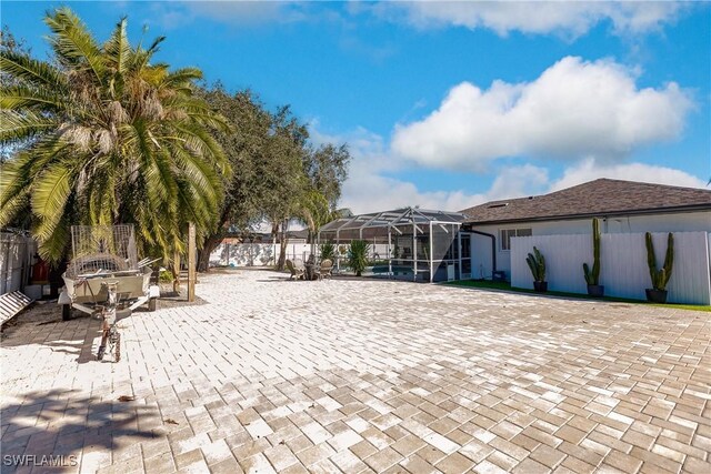 view of patio with glass enclosure