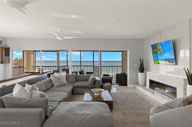 living room with a healthy amount of sunlight and a high end fireplace