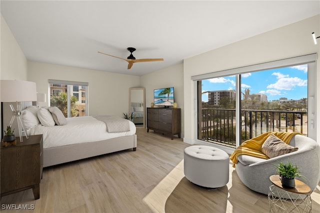 bedroom featuring ceiling fan, access to exterior, and light hardwood / wood-style flooring