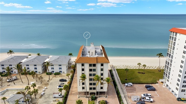 drone / aerial view with a water view and a beach view