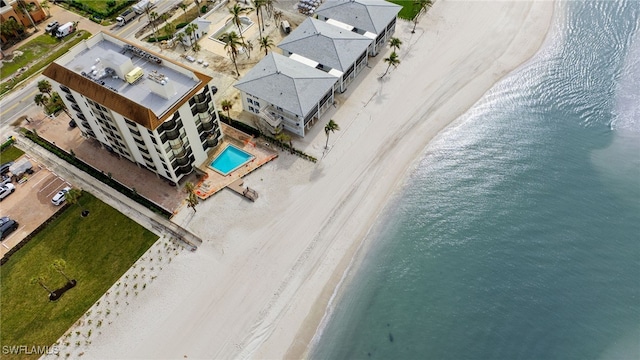 bird's eye view featuring a view of the beach and a water view