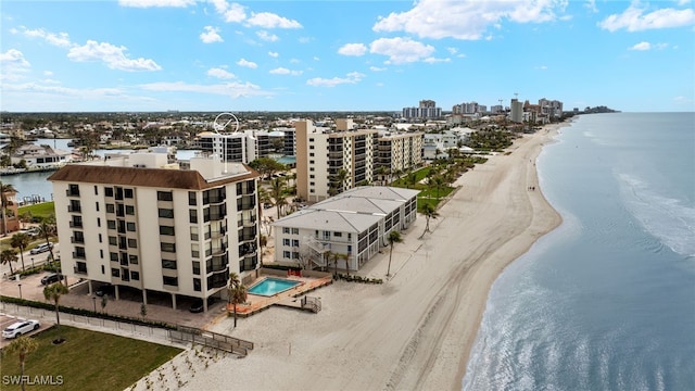 drone / aerial view with a water view and a beach view