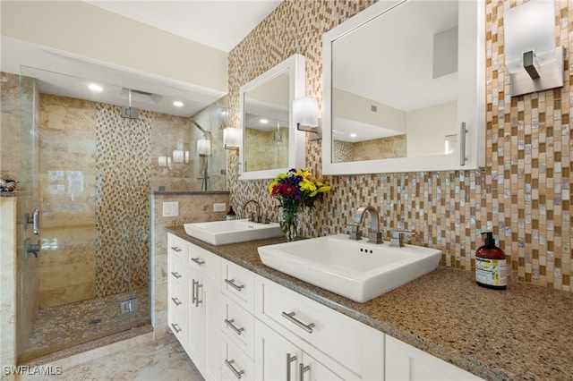 bathroom with tasteful backsplash, vanity, tile walls, and a shower with shower door