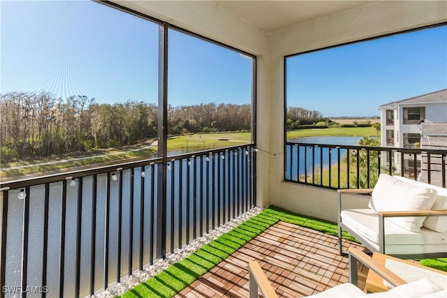 unfurnished sunroom featuring a water view