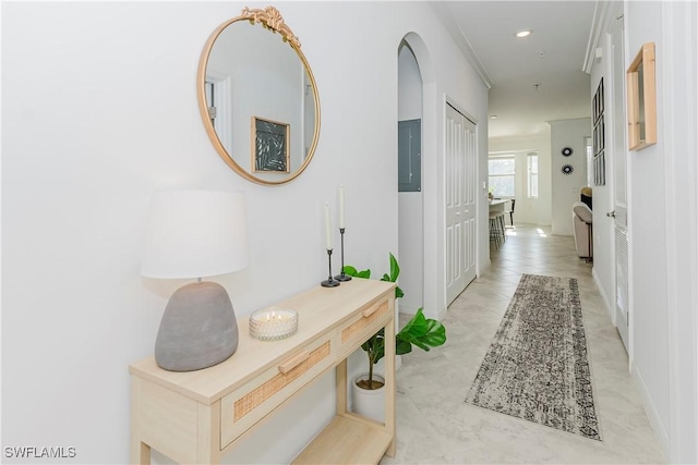 hallway featuring electric panel and light tile patterned flooring