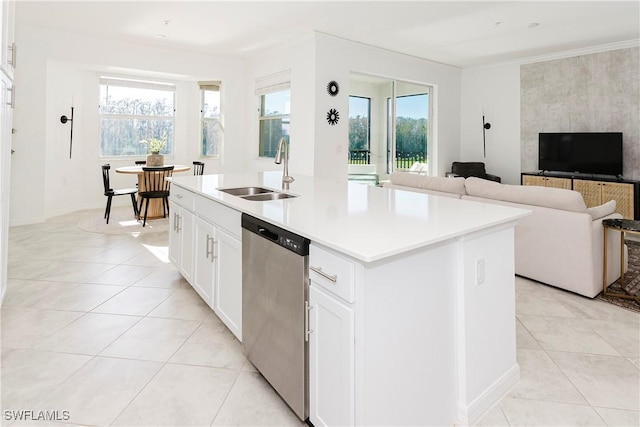 kitchen with stainless steel dishwasher, sink, white cabinetry, plenty of natural light, and an island with sink