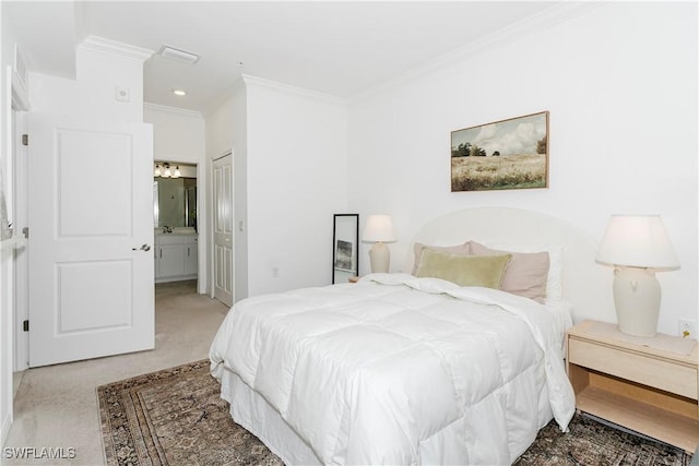 bedroom with sink, crown molding, ensuite bath, carpet floors, and a closet