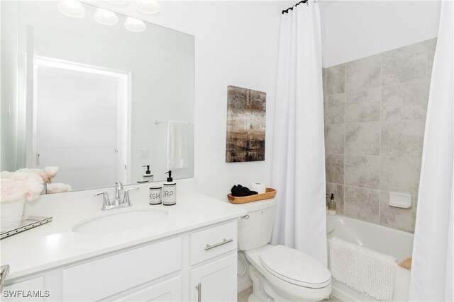 full bathroom featuring shower / bath combo, vanity, and toilet