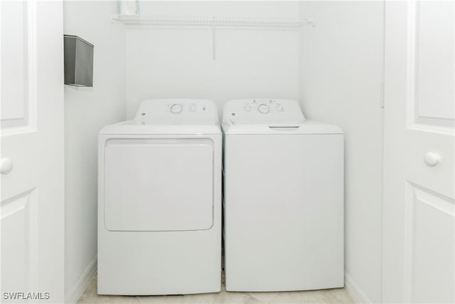 washroom with washing machine and clothes dryer