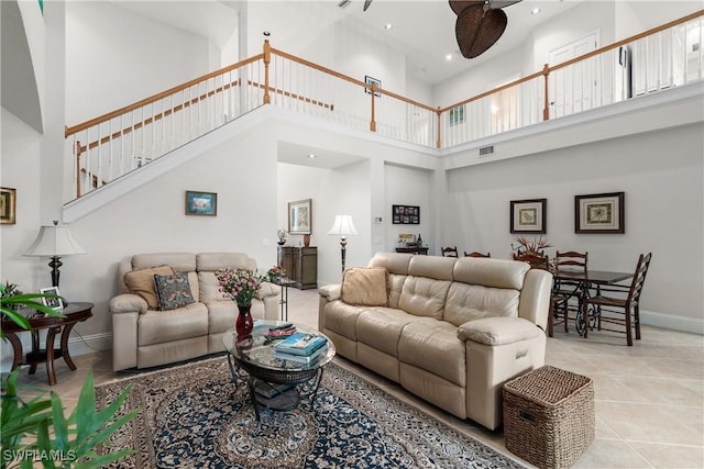 tiled living room featuring a towering ceiling and ceiling fan