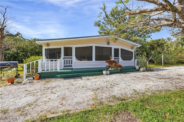 view of front of home with a sunroom