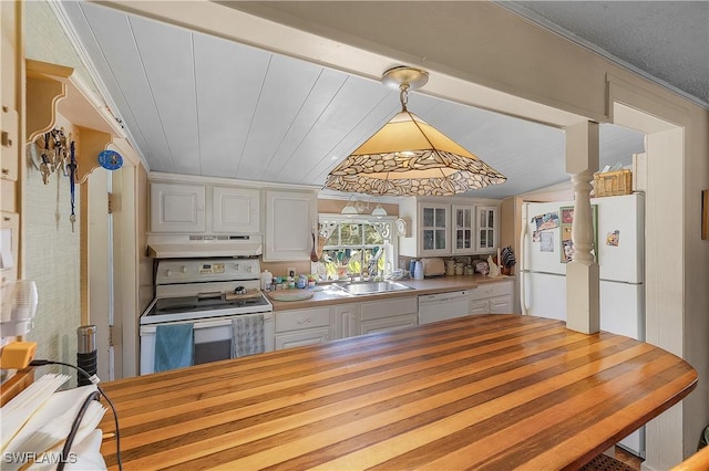 6253 Valeria Rd, Bokeelia, FL 33922 - kitchen with white cabinets, white appliances, hanging light fixtures, and sink
