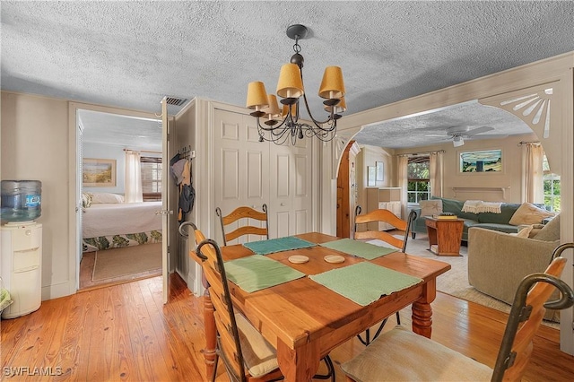 6253 Valeria Rd, Bokeelia, FL 33922 - dining area featuring a textured ceiling, hardwood / wood-style floors, and ceiling fan with notable chandelier