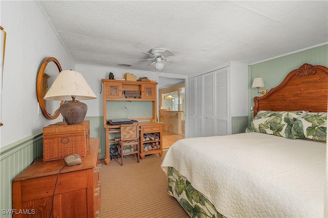 6253 Valeria Rd, Bokeelia, FL 33922 - bedroom featuring light carpet, ensuite bath, ceiling fan, a textured ceiling, and a closet