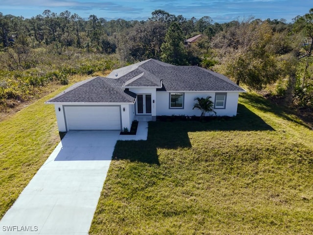 ranch-style house featuring a front yard and a garage