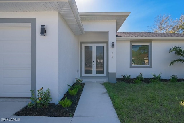 property entrance with a garage and french doors