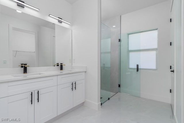 bathroom featuring vanity and a shower with shower door