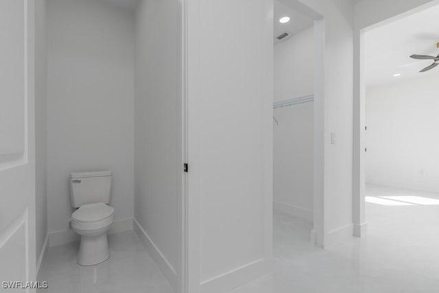 bathroom featuring ceiling fan and toilet