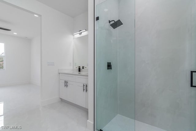 bathroom featuring vanity and a shower with door