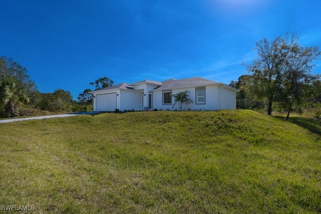 single story home with a front lawn and a garage