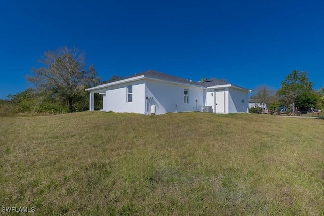 rear view of house with a yard