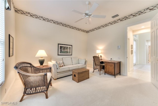 carpeted living room featuring ceiling fan