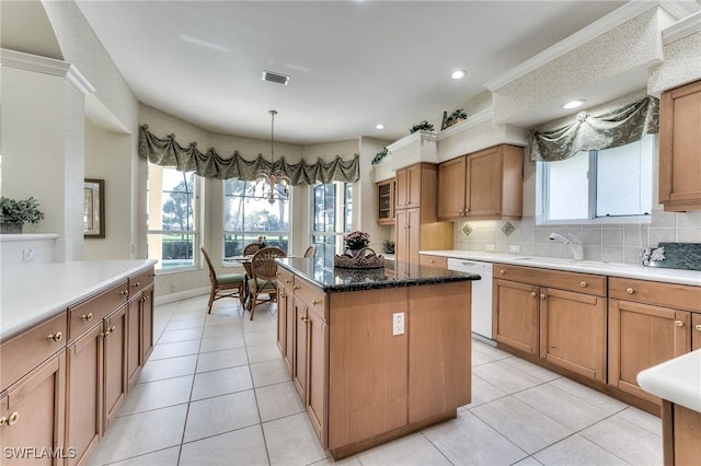 kitchen with pendant lighting, light tile patterned floors, a kitchen island, backsplash, and white dishwasher