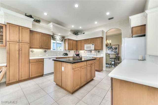 kitchen featuring a kitchen island, white appliances, decorative backsplash, and light tile patterned flooring